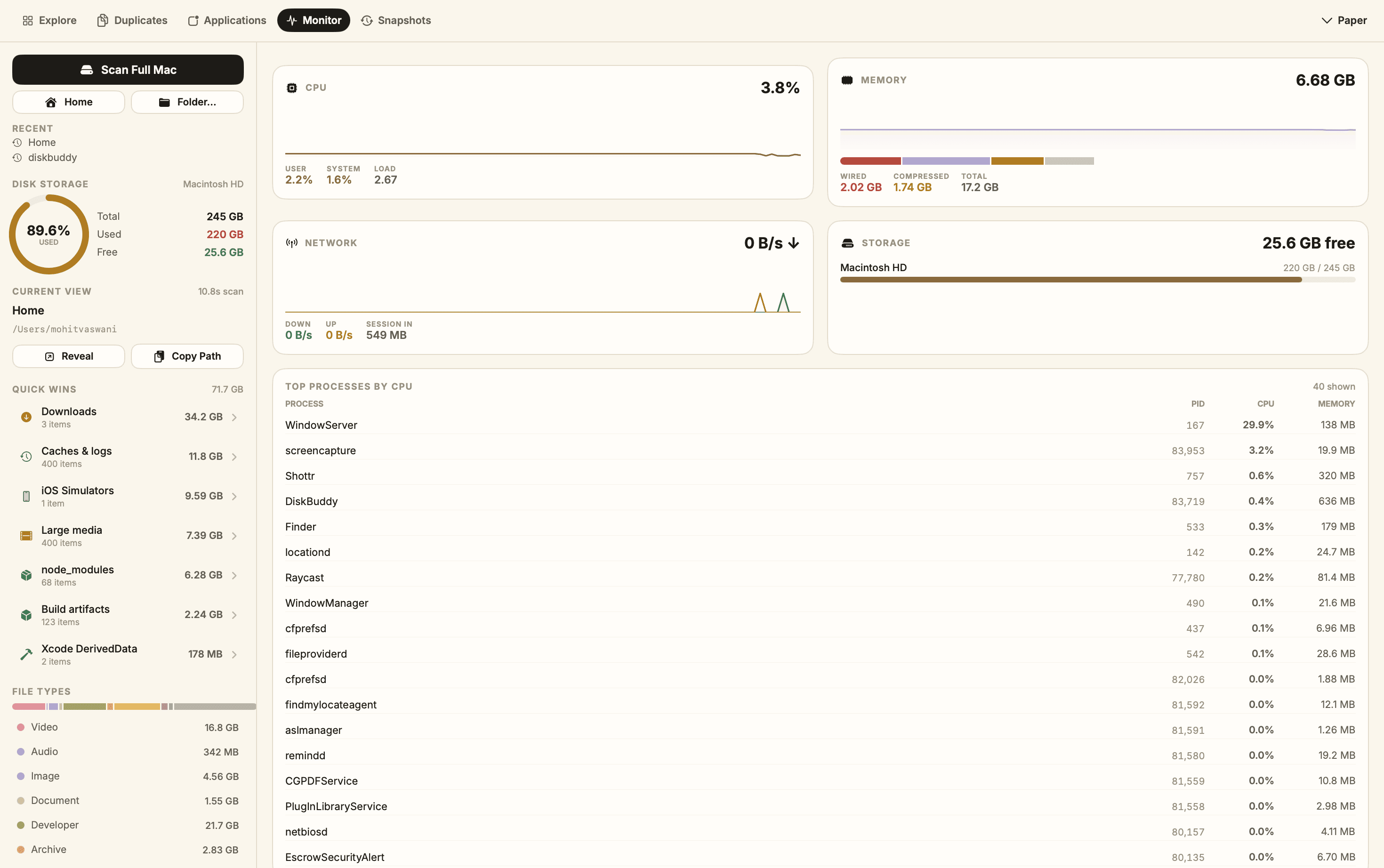 DiskBuddy Monitor tab showing live CPU, memory, network and storage panels above a ranked process list.